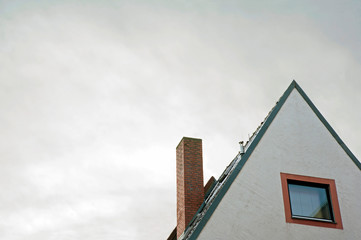 Detail of a sloping rooftop covered with snow.