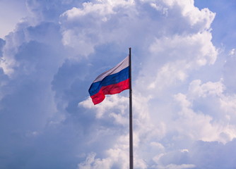 Flag of Russian Federation with cloudy sky on the background