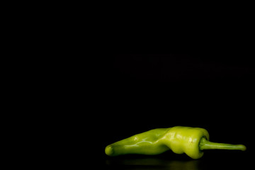 Green chili or Bell pepper isolated on black background. Food organic, Close up, Fresh pepper.