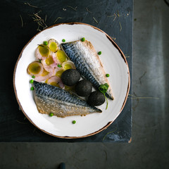 Restaurant dish with mackerel and onions
