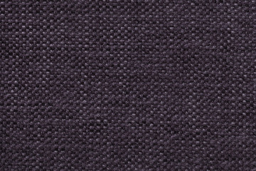 Dark violet knitted woolen background with a pattern of soft, fleecy cloth. Texture of textile closeup.