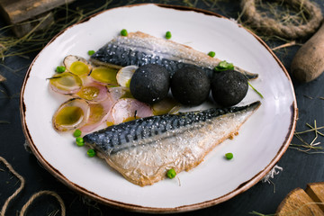 Restaurant dish with mackerel and onions