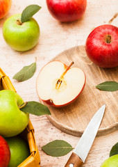 Fresh organic red and green on chopping board on wooden background with sun light
