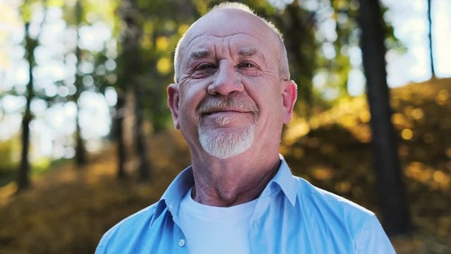 Portrait Of Smiling Bald Senior Man Looking At Camera. Portrait Of Happy Mature Grandfather Smiling