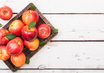 Healthy red organic  apples in vintage box on wooden background.
