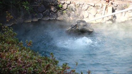 View of the hot thermal spring framed by granite boulders.Japan, Beppu
