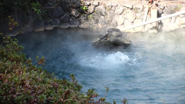 View of the hot thermal spring framed by granite boulders.Japan, Beppu