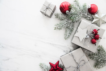 Christmas silver handmade gift boxes on white marble background top view. Merry Christmas greeting...