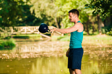 Handsome man exercising with a keetlebell