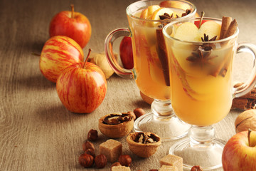 Two cups with hot cider in cold season with cinnamon and anise
