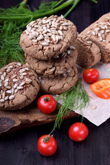 Wholegrain gluten-free buckwheat bread with sunflower and flax seeds. Cherry tomatoes are around