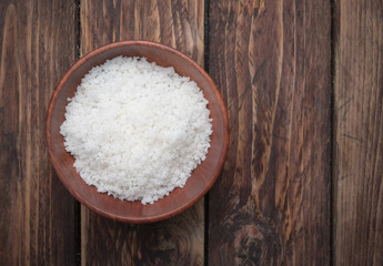Fototapeta na wymiar Sea salt in wooden bowl on the wooden table,top view
