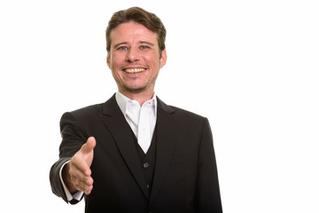 Happy Caucasian businessman giving handshake while smiling