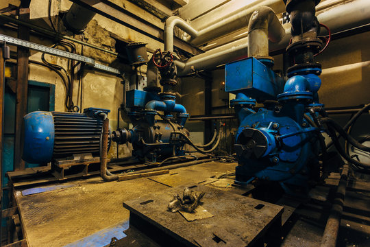 Old industrial electric compressors in cellar under factory