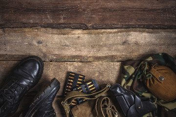 Army military uniform,mobilization war weapon, holster, pistol, flask, boots on wooden background....