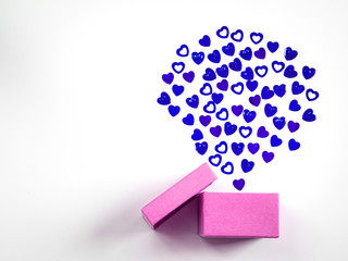 Pink gift box with violet heart confetti, white background. Colorful celebration concept.