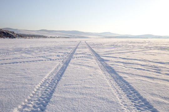 imprint of a truck tire in snow on Lake Baikal