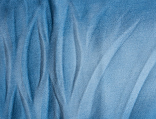 Fototapeta na wymiar Crumpled blue jeans fabric background