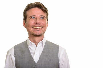 Happy formal Caucasian man thinking wearing vest