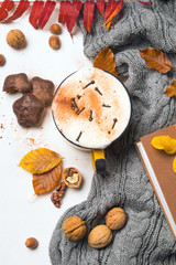Obraz na płótnie Canvas A mug of hot coffee surrounded by autumn leaves.