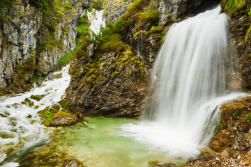 Naklejka na ściany i meble Alpine stream with waterfall in the Adamello Brenta natural park