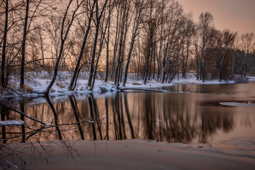 picturesque view of first snow on Ontario lake with dramatic sky, Canada
