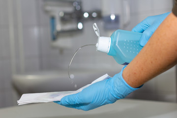 wipe desinketion of surfaces with towels and gloves