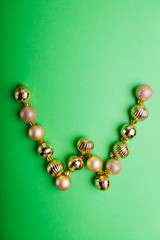 Letter W made of Christmas toys on green background. ABC