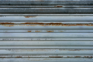 Close up of decaying rusted metal shutter door