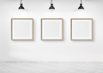 Three squared frames hanging on a wall mockup 3d rendering