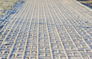 Fototapeta premium Sidewalk covered with fluffy snow.
