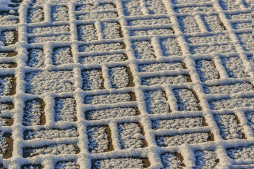 Sidewalk covered with fluffy snow.
