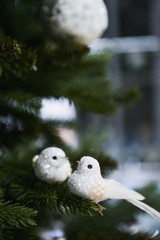 Christmas decor close-up, New Year's interior details, Christmas tree, balls on the branches, toys, candles, sock
