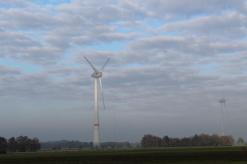 Windmill in front of a hazy autumn sky 