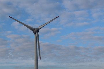 Windmill in front of a hazy autumn sky 