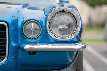 Close up of vintage blue car bumber and lamps