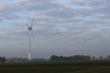 Windmill in front of a hazy autumn sky 