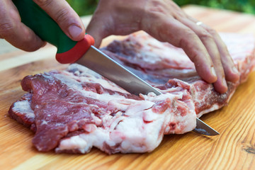 Butcher prepares pork ribs for cooking