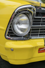 Close up of vintage yellow car bumber and lamps