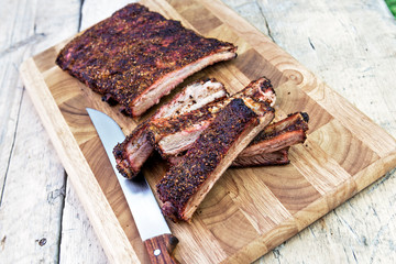Cutting pork ribs on cutting board