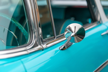 Close up of lue vintage car door and side mirror