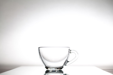 Glass cup for tea is on glass