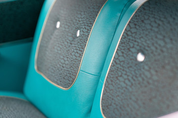 Close up of blue vintage car door seats