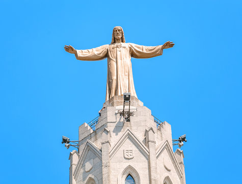 Famous Statue of Jesus Christ with open handed on top of the Church of the Sacred Heart on Tibidabo in Barcelona, Spain