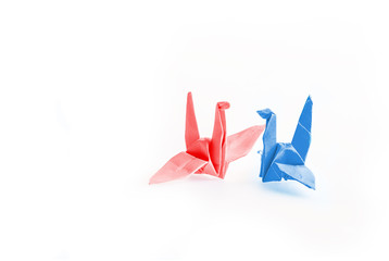 Couple of origami bird paper on white background faceing each others, friedship concept