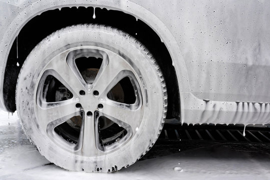 Car in foam.  Car washing concept. Autowashing. Cleaning of the car on car wash