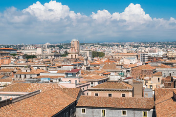 Fototapeta na wymiar Aerial skyline panoramic view of Catania in September, old town featuring brown and yellow roofs with Mount Etna at background. Sicily, Italy 