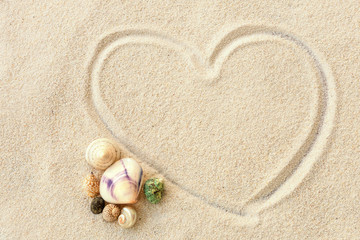 Fototapeta na wymiar Heart shape on the sand beach and sea shells, Love on the beach concept