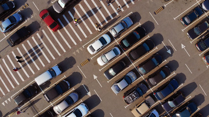 A fragment of a parking lot with cars and pedestrian crosswalk near the shopping mall © Dmytro