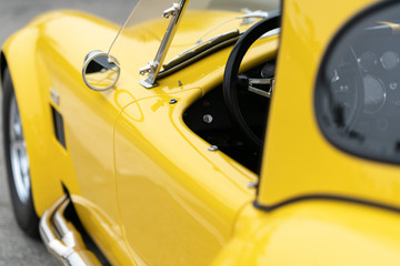 Close up of side of yellow vintage car
